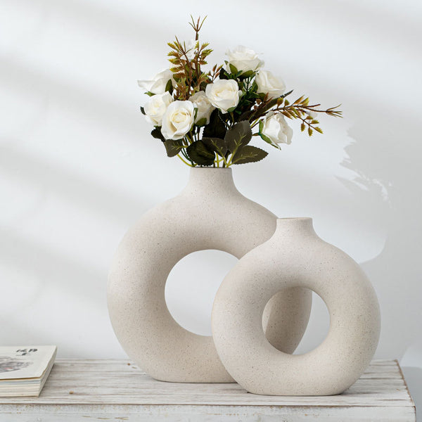 Circular donut shaped off-white/cream ceramic vases