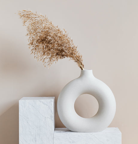Circular donut shaped off-white/cream ceramic vases